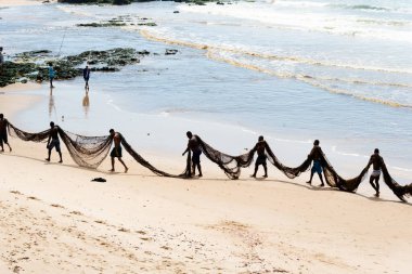 Salvador, Bahia, Brezilya - 25 Aralık 2018: Birkaç balıkçının bir hat üzerinde yürüdüğü ve büyük bir balık ağı taşıdığı görüldü. Bahia, Salvador şehri..