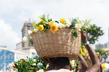 Salvador, Bahia, Brezilya - 2 Şubat 2024: Salvador, Bahia kentindeki Rio Vermelho plajında Iemanja için düzenlenen bir partide insanlar çiçek sandıkları taşırken görüldü.
