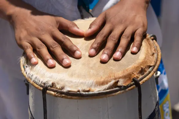 Percussionist\'s hands resting on top of the atabaque. African music.