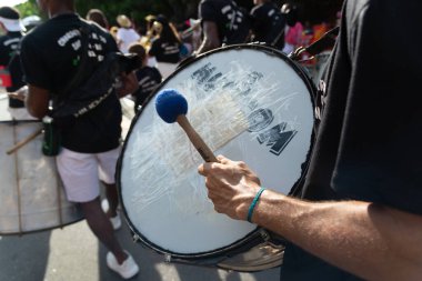 Salvador, Bahia, Brazil - February 03, 2024: Musicians are seen playing percussion instruments during Fuzue, pre-carnival in the city of Salvador, Bahia. clipart