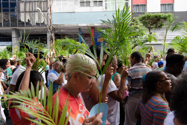 Salvador, Bahia, Brazil - April 14, 2019: Catholics are seen walking and praying during Palm Sunday celebration in the city of Salvador, Bahia.