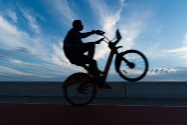 Salvador, Bahia, Brezilya - 19 Aralık 2021: Bisikletçi, Salvador, Bahia kentindeki Vemehro Nehri plajında manevra yaparken görüldü..