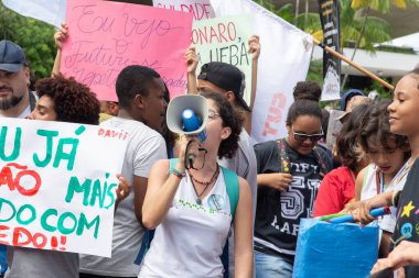 Salvador, Bahia, Brazil - August 13, 2019: Students are seen participating in a national demonstration against cuts to education by President Jair Bolsonaro in the city of Salvador, Bahia. clipart