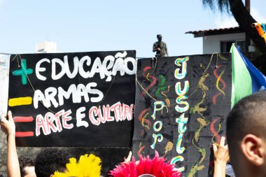 Salvador, Bahia, Brazil - August 13, 2019: Students are seen with signs during a protest against cuts to education by President Jair Bolsonaro in the city of Salvador, Bahia. clipart