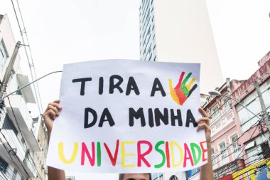 Salvador, Bahia, Brazil - May 15, 2019: Students are seen holding signs during a demonstration in favor of Brazilian education in the city of Salvador, Bahia. clipart