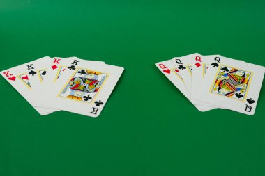 Playing cards isolated on green background. Gambling. clipart