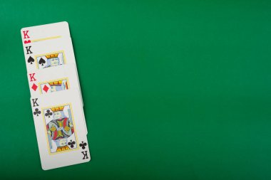 Playing cards for poker and gambling, isolated on green background. clipart