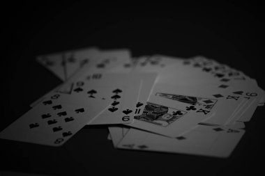 Black and white portrait of deck of cards on a table. Gambling. clipart