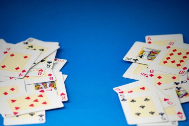 Playing cards isolated on blue background. Gambling. clipart