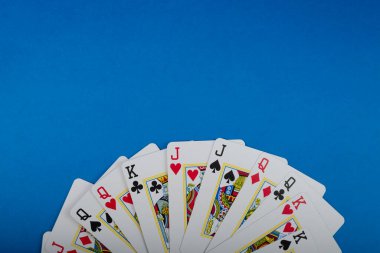Playing cards isolated on blue background. Gambling. clipart