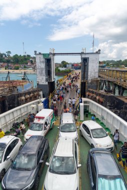 Vera Cruz, Bahia, Brazil - January 24, 2023: Passengers and vehicles are seen boarding the Ferry Boat in the city of Vera Cruz in Bahia. clipart