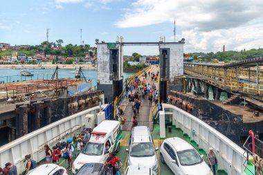 Vera Cruz, Bahia, Brazil - January 24, 2023: View of cars and passengers boarding the Ferry Boat in the city of Vera Cruz in Bahia. clipart