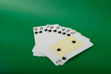 Playing cards isolated on green background. Gambling. clipart