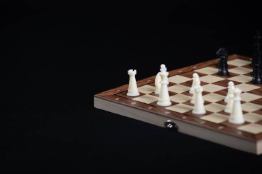 Aydınlık ve karanlık parçalı satranç tahtası. Oyun konsepti. Masa oyunu. Hobi olarak. Siyah arkaplanda bir oyun için oyun alanında satranç.