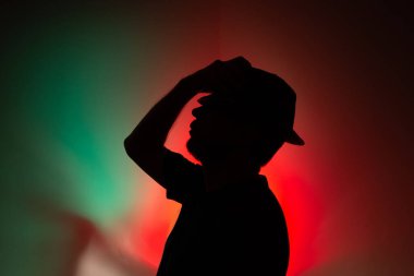 Silüet şapkalı bir adamın stüdyo portresi. Renkli arkaplanda izole.