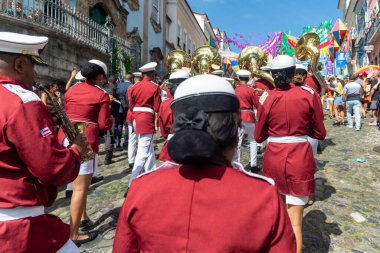 Salvador, Bahia, Brazil - June 02, 2024: Uniformed musicians climb the hill of Pelourinho during an independence celebration in Bahia. City of Salvador. clipart