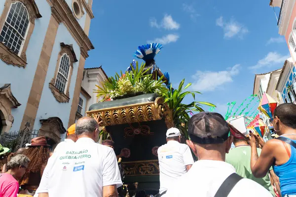 stock image Salvador, Bahia, Brazil - June 02, 2024: People are seen pushing a cart with Caboclo during the independence celebration in Pelourinho, city of Salvador, Bahia.