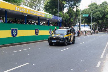 Salvador, Bahia, Brazil - September 07, 2024: A federal police patrol car with two agents is seen during a parade on Brazilian Independence Day in the city of Salvador, Bahia. clipart