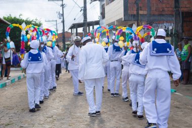 Saubara, Bahia, Brazil - August 03, 2024: A group of Marujada, dressed in character, are seen performing during a Chegancas meeting in the city of Saubara, in Bahia. clipart