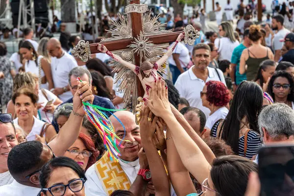 stock image Salvador, Bahia, Brazil - December 27, 2019: Catholics are seen touching the image of Jesus Christ during an open-air mass at the Bonfim church in Salvador, Bahia.