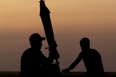 Salvador, Bahia, Brazil - September 12, 2019: Two unidentified people are seen in silhouette during a dramatic sunset in the city of Salvador, Bahia. clipart