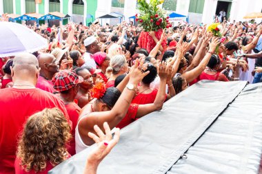 Salvador, Bahia, Brazil - December 04, 2019: Hundreds of Catholics and members of Candomble are seen paying homage to Saint Barbara during a festival in Pelourinho, Salvador, Bahia. clipart