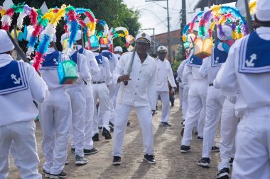 Saubara, Bahia, Brazil - August 03, 2024: Marujada cultural group dressed in typical clothes is seen dancing, singing and playing during a Chegancas meeting in the city of Saubara, Bahia. clipart