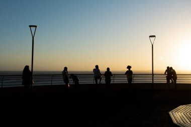 Salvador, Bahia, Brezilya - 19 Eylül 2019: Silüet içinde, Bahia 'nın Salvador şehrinde günbatımının tadını çıkaran insanların görüntüsü.
