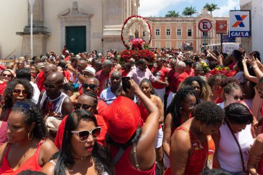 Salvador, Bahia, Brazil - December 04, 2019: Catholic and Candomble believers are seen participating in the Santa Barbara procession in the historic center of the city of Salvador, Bahia clipart