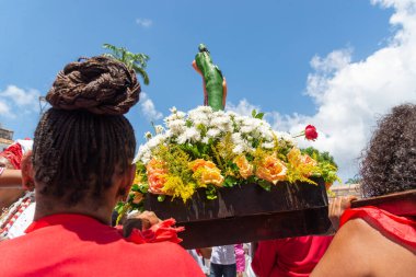 Salvador, Bahia, Brazil - December 04, 2019: Catholics are seen carrying images of saints during the Santa Barbara procession in the historic center of the city of Salvador, Bahia clipart