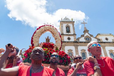 Salvador, Bahia, Brazil - December 04, 2019: Image of Saint Barbara is carried by believers during a procession in the historic center of the city of Salvador, Bahia clipart