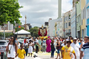 Salvador, Bahia, Brazil - January 01, 2025: Faithful carry the statue of Bom Jesus dos Navegantes on the first day of 2025 to the Galiota boat. Salvador, Bahia. clipart