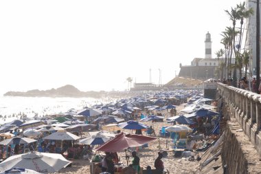 Salvador, Bahia, Brezilya - 05 Ocak 2025: Kalabalık Farol da Barra plajında eğlenirken ve denizde banyo yaparken görülüyor. Salvador, Bahia. 