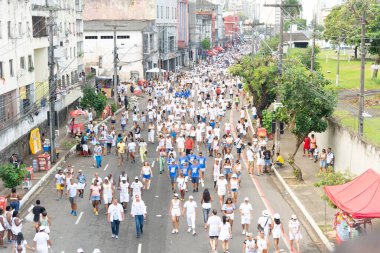 Salvador, Bahia, Brazil - January 16, 2025: Catholics are seen participating in the Lavagem do Bonfim festival in the city of Salvador, Bahia. clipart