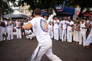 Salvador, Bahia, Brazil - January 16, 2025: A group of capoeiristas is seen playing capoeira during the Bonfim washing festival. Salvador, Bahia. clipart