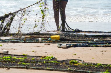 Kimliği belirsiz bir balıkçının balık ağını çektiği yarım ceset. Deniz ürünleri, hobi. Brezilya