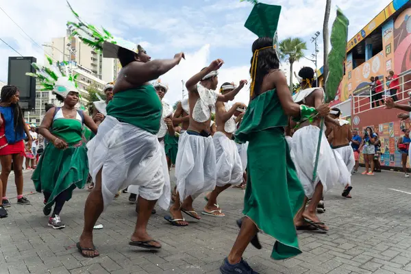 Salvador, Bahia, Brezilya - 01 Mart 2025: Bahia kentinin Salvador kentindeki karnaval geçidinde çok sayıda insandan oluşan geleneksel kültür grubu dans ederken görülüyor.