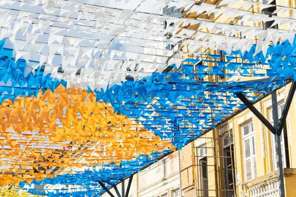 Haziran festivalinin renkli bayraklarla süslenmesi. Üstte plastik nesneler var. Pelourinho, Brezilya.