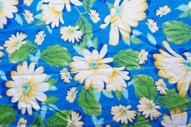 Çerçevesinde çiçekler olan mavi renkli kumaş. Geometrik desen. Geçmişi. Soyut. Boşluğu kopyala.