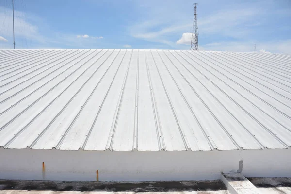 stock image metal sheet roofing on commercial construction with blue sky