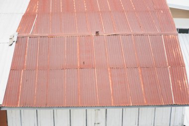 The tin roof is rusty.