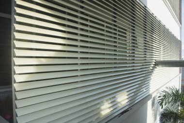 Stainless steel awning on the balcony of a modern business building clipart