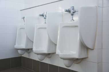 Zemin ayakta duran pisuvar, erkek umumi tuvalet, erkekler tuvaletinde kapalı beyaz pisuar, erkekler için beyaz seramik sidik tasarımı.