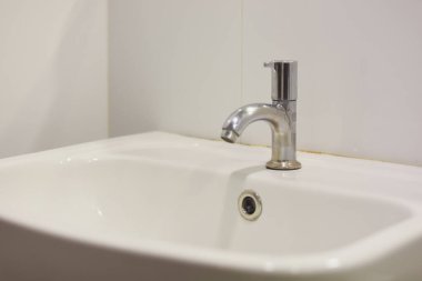 Banyoda paslanmaz çelik musluk var.