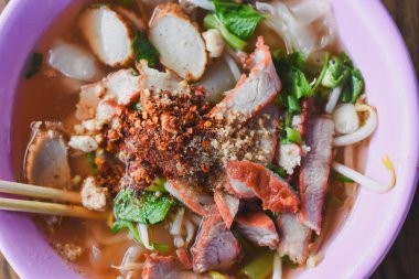 Clear soup noodles with pork and vegetables and fish balls and red pork