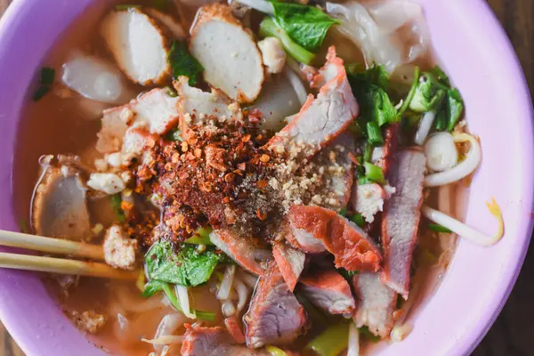 Clear soup noodles with pork and vegetables and fish balls and red pork
