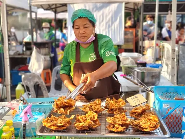 Songkhla-Tayland. 29 Ekim 2022 - Dişi bir tüccar bit pazarında haşlanmış karides kızartıyor.
