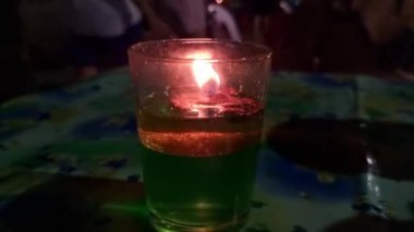 Orange flame from an oil lamp in a glass