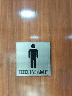 Male Executive Signage on a Wooden Eco Door: A Sophisticated Office Entrance Design clipart