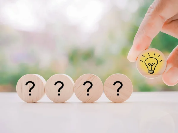 stock image Close up hand arranging wooden block with light bulb and wooden block with question mark for leadership, creative, idea, innovation concept.